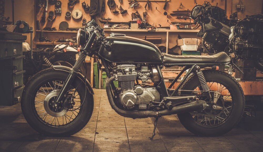 custom cafe racer motorcycle in a garage with insurance