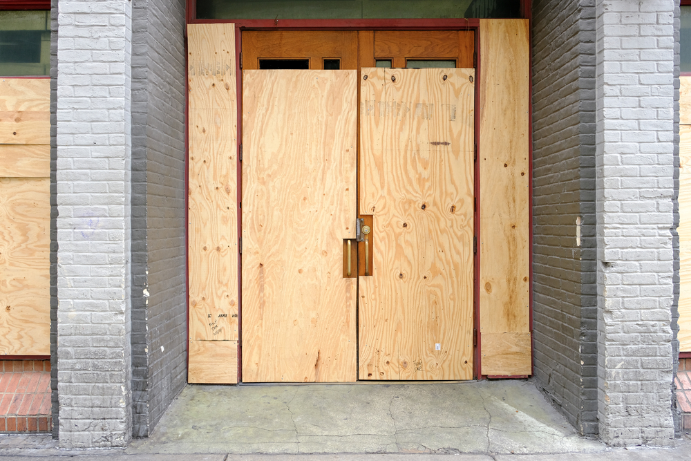 business location with boarded up front doors