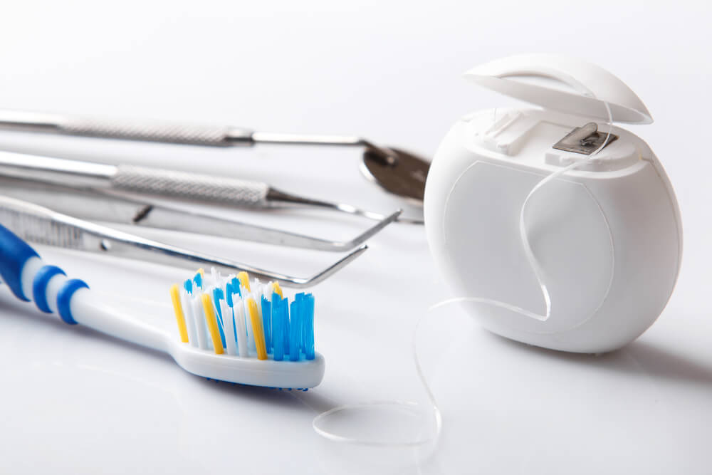 dental floss and brush for better tooth health