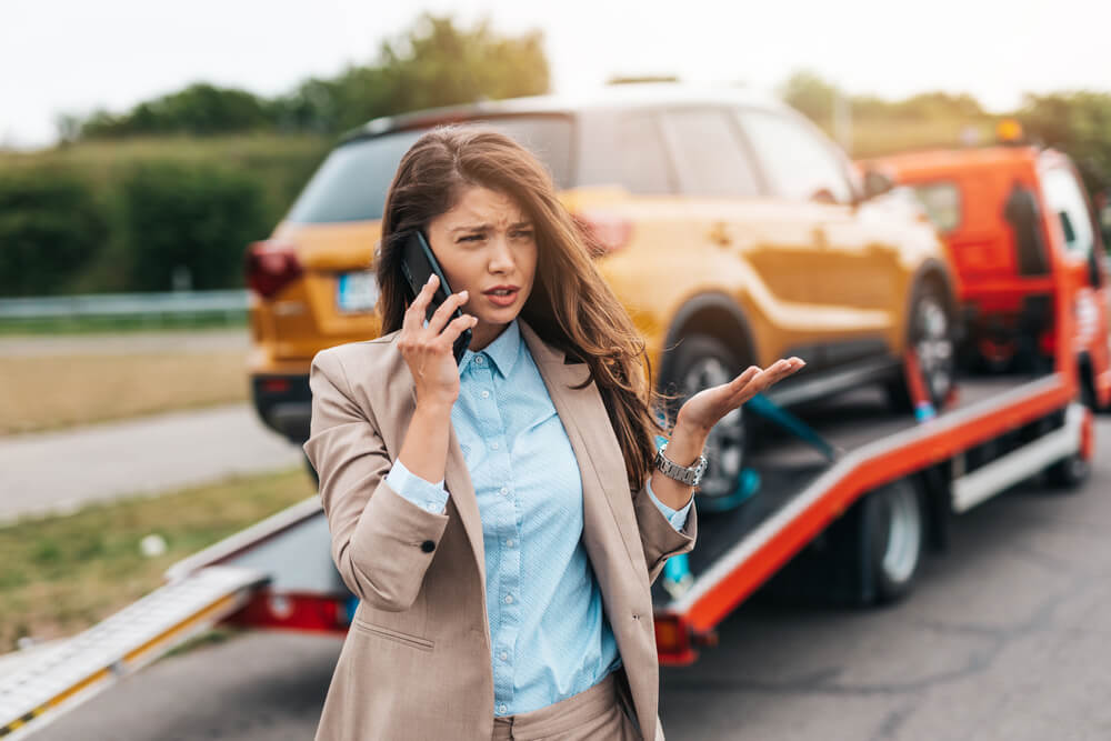 Young woman calling her insurance company to report an accident with an uninsured driver.