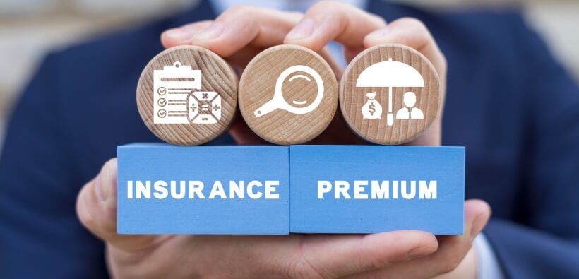 Hand holding a sign that says Insurance Premium