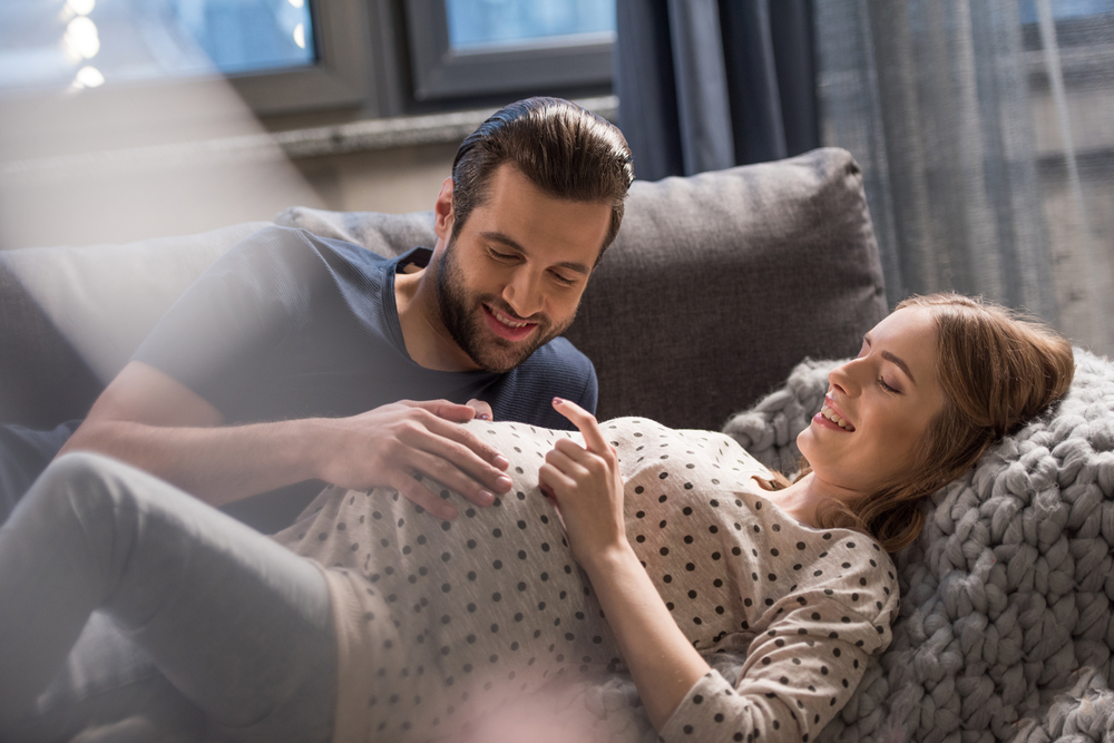 Couple with pregnant wife contemplating life insurance