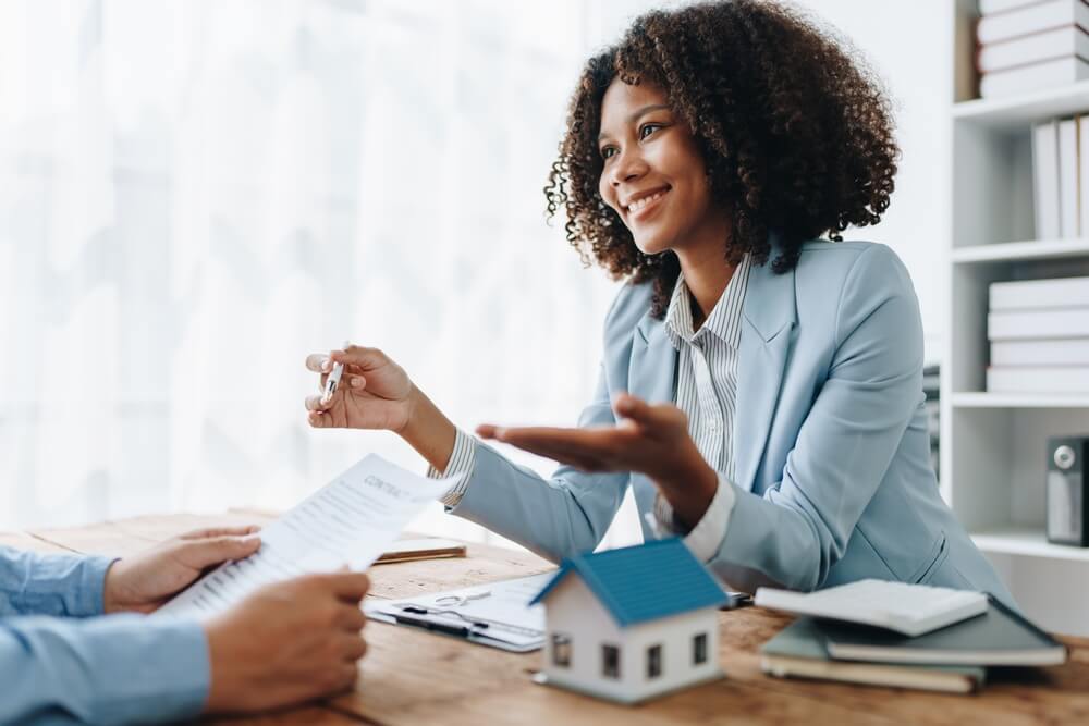 Female insurance agent explaining home insurance policy to a Californian.