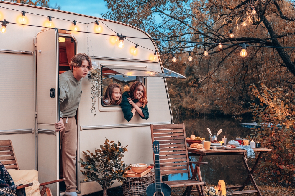 3 kids hang out of the windows of the RV