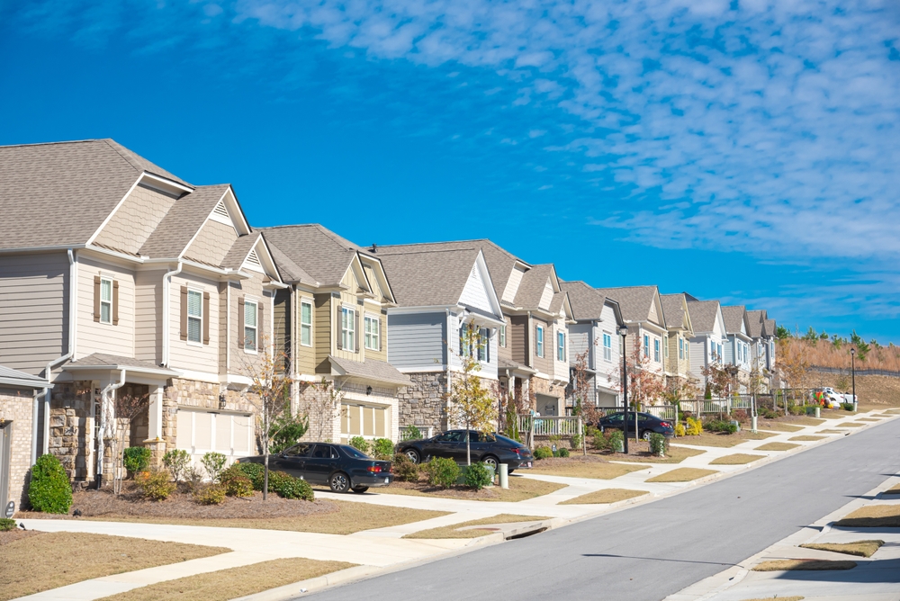 Row of townhomes in a planned community, illustrating how an HOA can affect your homeowners insurance coverage and responsibilities.