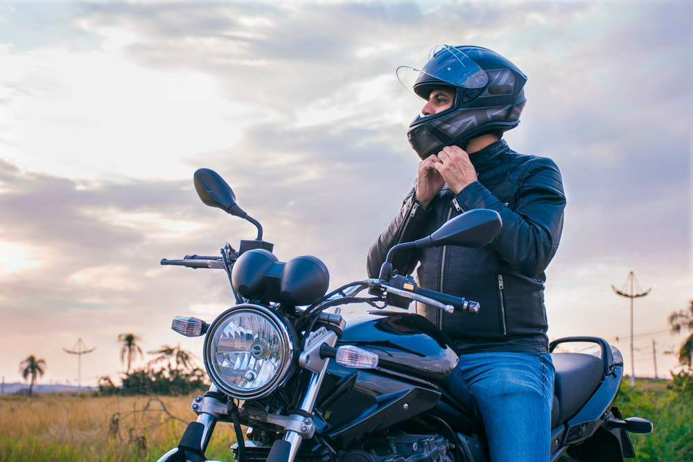 man sitting on motorcycle