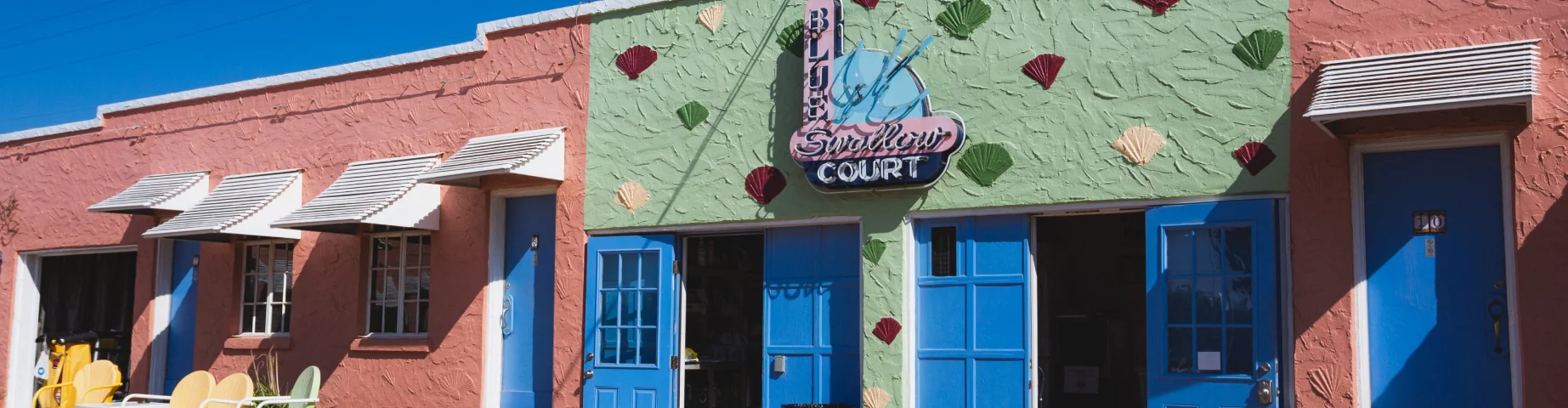 Tucumcari, New Mexico - September 6, 2020: Sunlight at the laundry room and neon signs at the historic Blue Swallow Motel on Route 66 – Home insurance in New Mexico